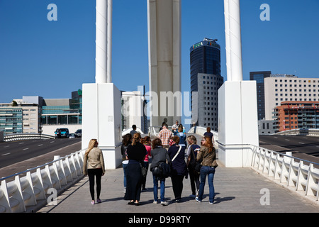 people walking across the assut de l'or bridge at city of arts and sciences ciutat de les arts i les ciencies valencia spain Stock Photo