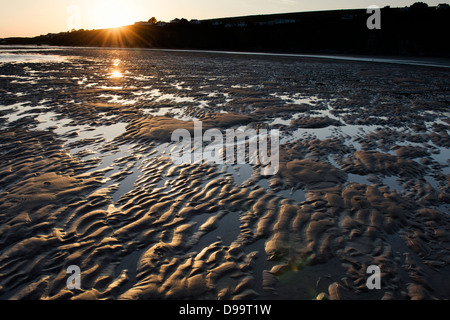 Rippled sand and sea water on Bantham beach at sunset.  Devon, England Stock Photo