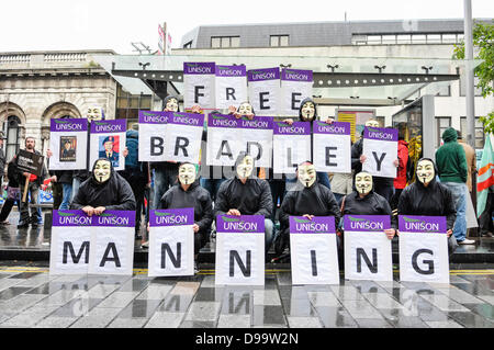 Belfast, Northern Ireland. 15th June 2013. Members and supporters of the hacking group Anonymous wear Guy Fawkes masks and hold posters spelling out 'Free Bradley Manning' Credit:  Stephen Barnes/Alamy Live News Stock Photo