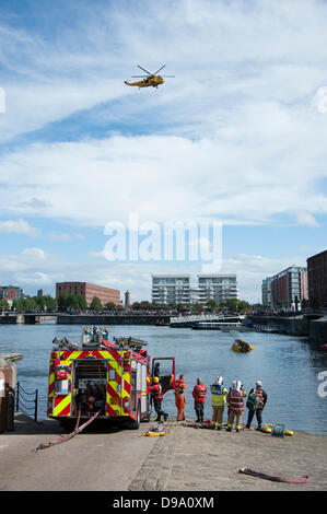 Yellow DuckMarine Amphibious Tourist Vehicle sinks at Albert Dock Liverpool UK. Fire & Rescue Service rescue passengers. Stock Photo