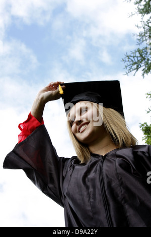A young woman graduating with a diploma certificate Stock Photo