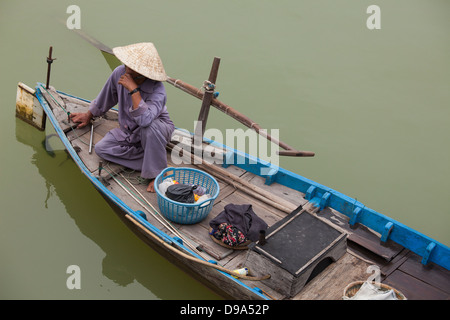 Man in boat on river near Hoi An, Vietnam Stock Photo