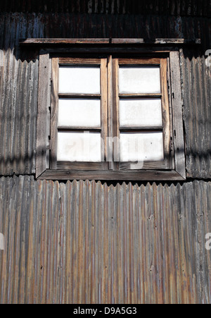 Old vintage window and rusty corrugated wall Stock Photo