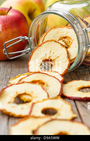 Dried apples rings  spilling from a jar Stock Photo