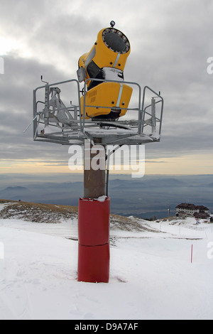 Snow cannon gun, artificial snow making machine on the slopes of a ski  resort, ski lift and piste Stock Photo - Alamy