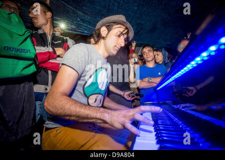 German pianist Davide Martello plays piano in pouring rain at the Taksim Square in Istanbul on 15 June 2013./dpa/Alamy Live News Stock Photo