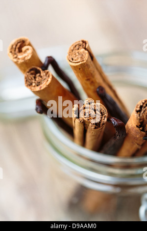 Cinnamon and vanilla sticks in a glass container Stock Photo