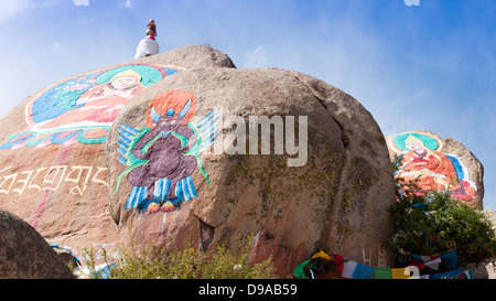 Buddha statue painted on huge stone at Drepung Monastery, Lhasa, Tibet, Drepung Monastery which was founded in 1416. Stock Photo