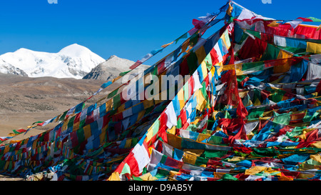 Tibetan prayer flags with ancient buddhism symbols and prayers written in sanskrit . Stock Photo