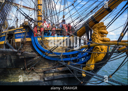 Rouen, France. 15th June, 2013. Spectators stand at the prow of the Swedish Tall ship Gotheborg at the Rouen Armada. The figurehead is a beautifully carved golden lion. Credit:  Christine Gates/Alamy Live News