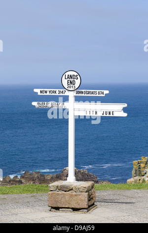 The Lands End Signpost one of Cornwall's most iconic sights with sea and blue sky in Background