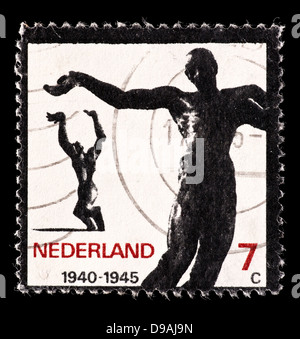 Postage stamp from the Netherlands depicting the statues 'Killed in Action' (Waalwijk) and 'Destroyed Town' (Rotterdam). Stock Photo
