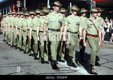 Australian soldiers with the 5th Battalion, Royal Australian Regiment march in an Anzac Day parade April 25, 2013 in Palmerston, Australia. Anzac Day commemorates Australian and New Zealand military personnel who served in all wars, conflicts and peacekeeping operations. Stock Photo