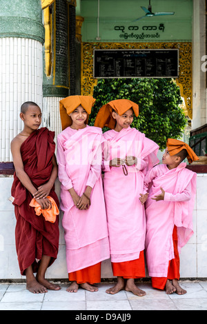 Young Buddhist nuns and monk at Shwedagon Pagoda or Great Dagon Pagoda or Golden Pagoda Yangon (Rangoon) Burma Myanmar Stock Photo