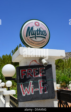 Mythos beer and free WiFi sign, Pefkos, Rhodes (Rodos), The Dodecanese, South Aegean Region, Greece Stock Photo