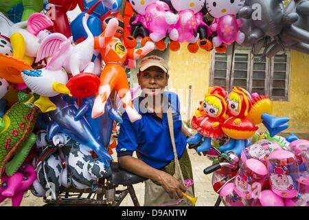 June 14, 2013 - Pathein, Ayeyarwady, Union of Myanmar - An inflatable toy vendor in Pathein, Myanmar. Pathein, sometimes also called Bassein, is a port city and the capital of the Ayeyarwady Region, Burma. It lies on the Pathein River (Bassein), which is a western branch of the Irrawaddy River. It's the fourth largest city in Myanmar (Burma) about 190 km west of Yangon. (Credit Image: © Jack Kurtz/ZUMAPRESS.com) Stock Photo