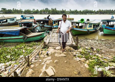 June 14, 2013 - Pathein, Ayeyarwady, Union of Myanmar - A passenger gets off a boat in Pathein, Myanmar. Boats are still a main form of transportation in the Irrawaddy river delta. Pathein, sometimes also called Bassein, is a port city and the capital of the Ayeyarwady Region, Burma. It lies on the Pathein River (Bassein), which is a western branch of the Irrawaddy River. It's the fourth largest city in Myanmar (Burma) about 190 km west of Yangon. (Credit Image: © Jack Kurtz/ZUMAPRESS.com) Stock Photo