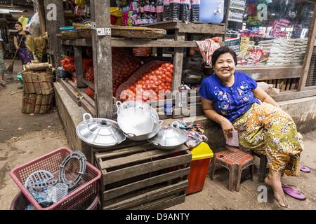 June 14, 2013 - Pathein, Ayeyarwady, Union of Myanmar - A vendor in the market in Pathein, Myanmar. Pathein, sometimes also called Bassein, is a port city and the capital of the Ayeyarwady Region, Burma. It lies on the Pathein River (Bassein), which is a western branch of the Irrawaddy River. It's the fourth largest city in Myanmar (Burma) about 190 km west of Yangon. (Credit Image: © Jack Kurtz/ZUMAPRESS.com) Stock Photo