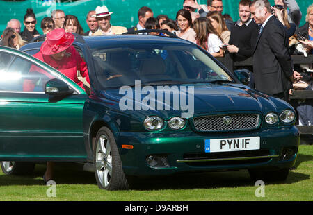 Egham, UK. 16th June, 2013. Britain's Queen Elizabeth II leaves in a car driven by herself for the Cartier Queen's Cup Final at Guards Polo Club in Egham, 16 June 2013. Photo: Albert Nieboerdpa/Alamy Live News Stock Photo