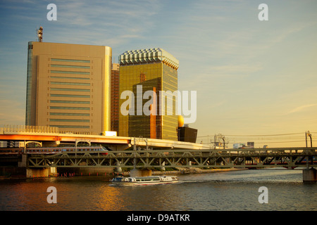 Asahi Beer Hall by Sumida River in Evening Golden Glow Stock Photo