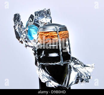 Champagne bottle with foil peeled away revealing cork Stock Photo