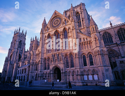 York Minster - a historic landmark - bathed in the last of the day's winter sunlight, against a pale blue sky. York, Yorkshire, England, UK. Stock Photo