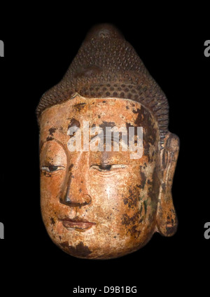 Buddha Head - Bronze, (circa 1368-1644)  Ming dynasty.  This head is all that remains of a statue, presumably from a temple.  Hollow inside, it is made of bronze cast in section moulds.  The bronze surface was covered with a layer of kaolin then painted with coloured pigments.  At some early sage, the surface began to flake and it was then covered with layers of linen-fibre paper. Stock Photo