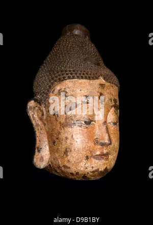 Buddha Head - Bronze, (circa 1368-1644)  Ming dynasty.  This head is all that remains of a statue, presumably from a temple.  Hollow inside, it is made of bronze cast in section moulds.  The bronze surface was covered with a layer of kaolin then painted with layers of linen-fibre paper. Stock Photo