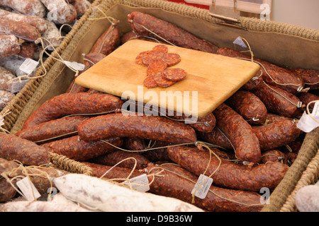 Dried speciality sausages on a market traders stall.
