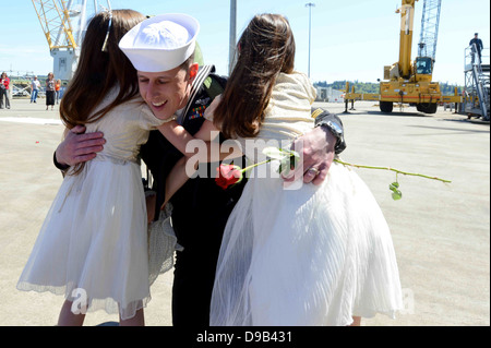 US Navy sailor Alexis Barnhart greets her family after returning from an eight month deployment on the USS John C. Stennis during homecoming at Naval Station Kitsap May 4, 2013 in Bremerton, Washington. Stock Photo