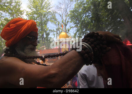 June 17, 2013 - Kashmiri (Pandit) Hindu devotee  prays at the Kheer Bhawani Temple at Tulla Mulla Ganderbal, northeast of Srinagar,the summer capital of indian   kashmir  ,on Monday 17/6/2013. Thousands of Hindu devotees attended the prayers in the historic Kheer Bhavani Temple. A large portion of Hindu community (locally called Pandits) migrated from the Muslim majority areas of the Indian Kashmir to Jammu city and northern states of India after anti-Indian armed insurgency broke down in the region in 1989. At least 219 Kashmiri Hindus were killed in the two decade long militancy in the regio Stock Photo