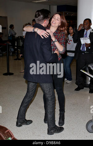 Arctic Monkeys star Alex Turner engages in a very public display of affection with Arielle Vandenberg as he arrives at LAX Airport. Arielle planted a big kiss on the rocker after jumping into his arms and wrapping her legs around him after he entered the arrivals hall. Turner split from TV personality Alexa Chung in 2011 Los Angeles, California - 12.02.12 Stock Photo