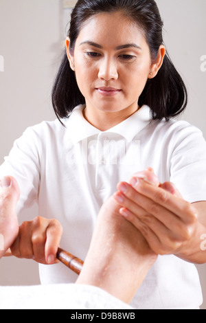 Asian Girl Masseuse Giving Foot Massage In Health Spa Room Taipei