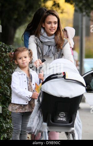 Honor Marie Warren hitches a ride on her sisters stroller as mom Jessica Alba pushes them back to their car during a family day out at Coldwater Park Beverly Hills, California - 12.02.12 Stock Photo