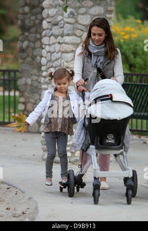 Honor Marie Warren hitches a ride on her sisters stroller as mom Jessica Alba pushes them back to their car during a family day out at Coldwater Park Beverly Hills, California - 12.02.12 Stock Photo