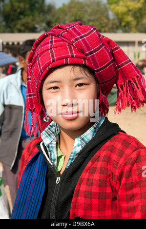 Pretty Pa-O girl wearing a red checked headdress looking at the camera in a market Myanmar (Burma) Stock Photo