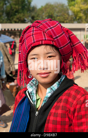 Pretty Pa-O girl wearing a red checked headdress looking at the camera in a market Myanmar (Burma) Stock Photo