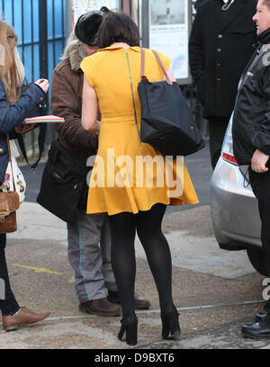 Natalie Cassidy wearing a mustard coloured dress as she leaves a pub at lunch time London, England - 26.01.12 Stock Photo