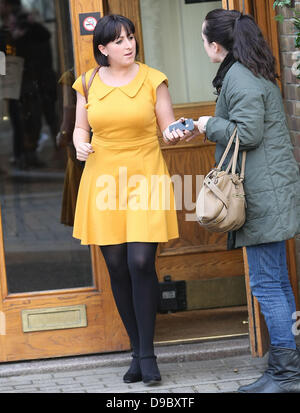 Natalie Cassidy wearing a mustard coloured dress as she leaves a pub at lunch time London, England - 26.01.12 Stock Photo