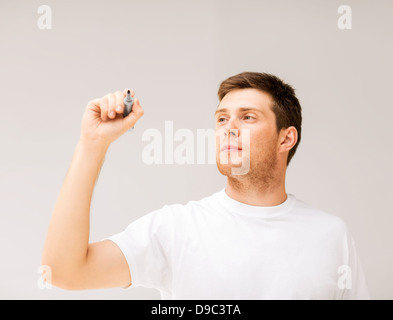 man writing something in the air Stock Photo