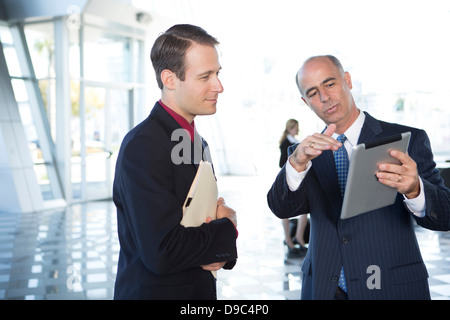 Two businessmen using digital tablet Stock Photo