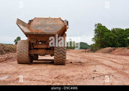 Heavy industrial dumper truck at a new road construction site Stock Photo