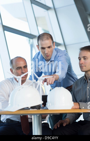 Engineers with model wind turbines Stock Photo