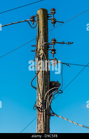 Old rustic wooden telegraph post. Stock Photo