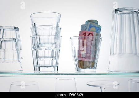 Euro banknotes in glass on shelf Stock Photo