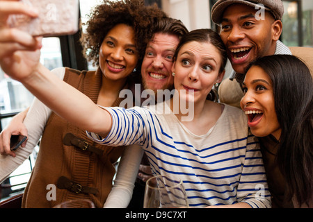 Friends taking photos using smart phone Stock Photo