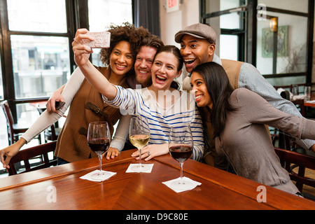 Friends taking photos using smart phone Stock Photo