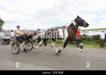 Gypsies drive their horses on the 'flashing lane' or 'mad mile' to show off to buyers at Appleby Horse Fair, in Cumbria, England Stock Photo