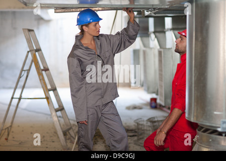 Engineers discussing air conditioning equipment Stock Photo
