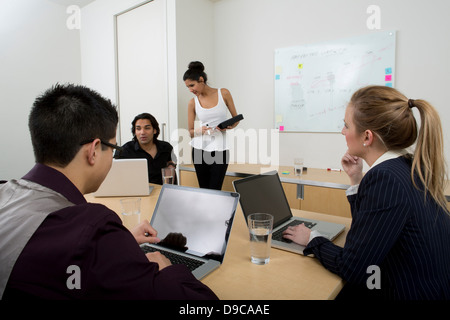 Young businesspeople using laptops Stock Photo